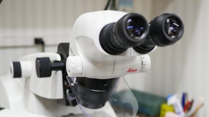 White microscope with black viewing lenses