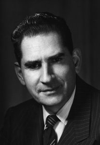 Black and white photo of person in suit and tie