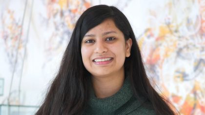 Person with long, dark hair smiling