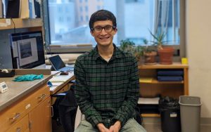 Man with Plaid shirt smiling in lab