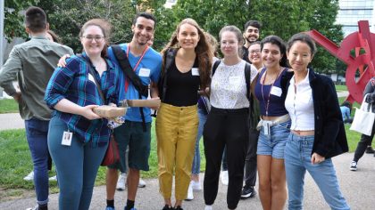 Group of students smiling outside