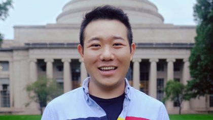 Man smiling outside the MIT dome